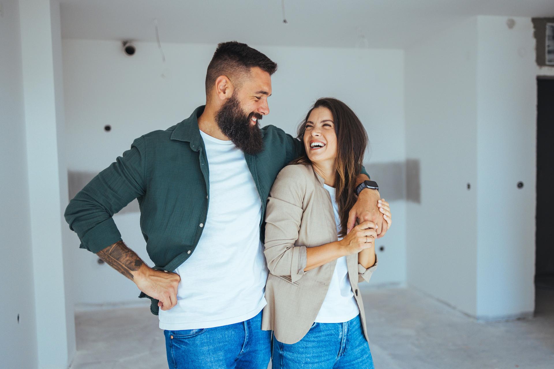 Joyful Caucasian Couple in New Apartment