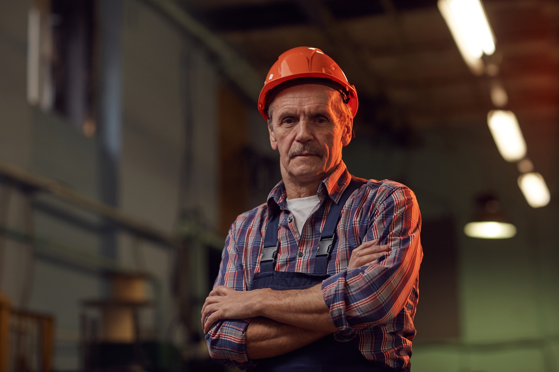 Worker in work helmet in the plant